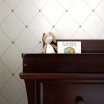 stuffed animal on top of a piano