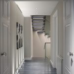 hallway with white doors and a staircase