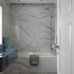 bathroom with a marble wall